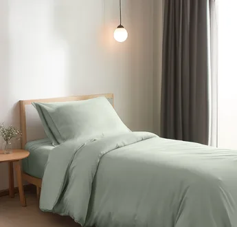 Bamboe dekbedovertrek Sage Green (saliegroen) op een opgemaakt eenpersoonsbed